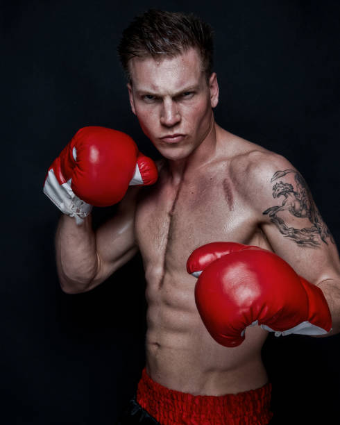 istock Sexy male boxer on black background 1170536067
