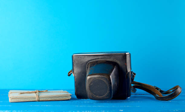 istock old film camera in a brown leather case on a blue background 1170536777