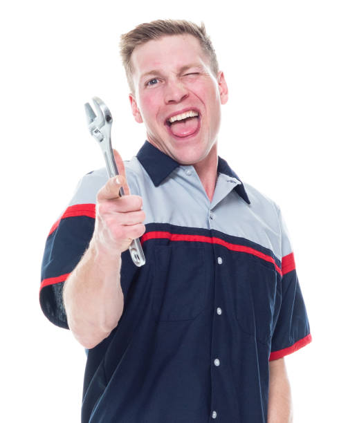 istock Attractive young male mechanic standing on white background - finger gun 1170536792