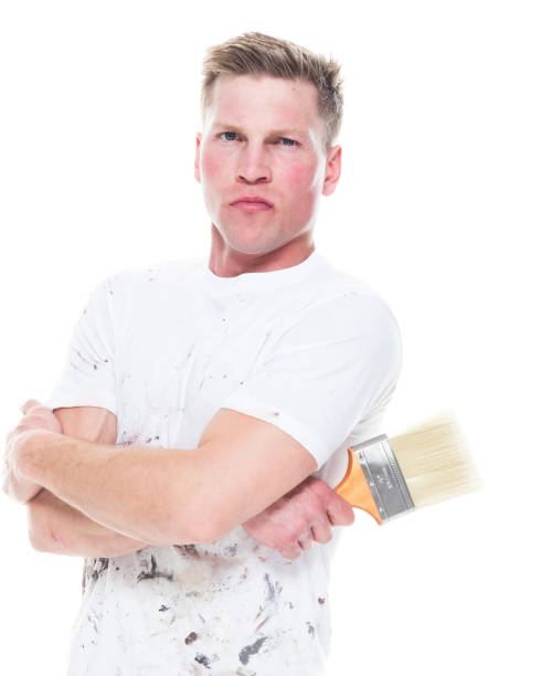 istock Young attractive male painter standing on white background - serious 1170536936