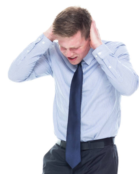 istock Handsome businessman standing on white background - headache 1170537441