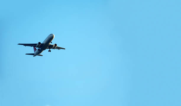 istock flying commercial passenger airplane over blue sky 1170539906