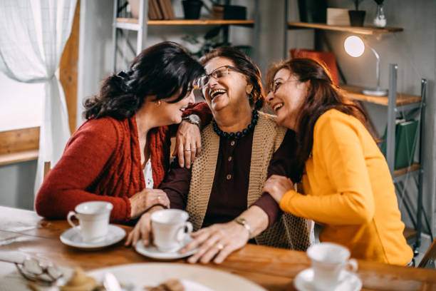 istock Three old women making conversation at home, having small tea party 1170540427