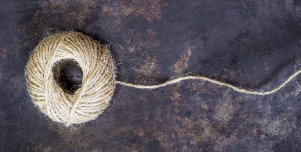 istock Jute twine roll on a rusty metal background, web banner 1170540447