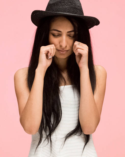 istock Beautiful female on pink background is crying 1170540466