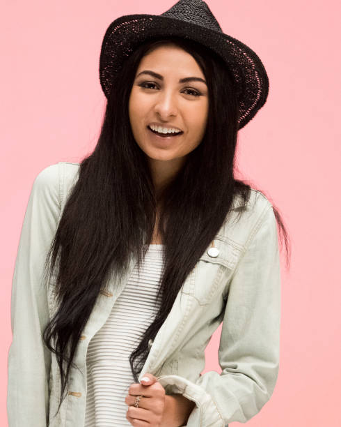 istock Beautiful female on pink background is looking trendy 1170541581