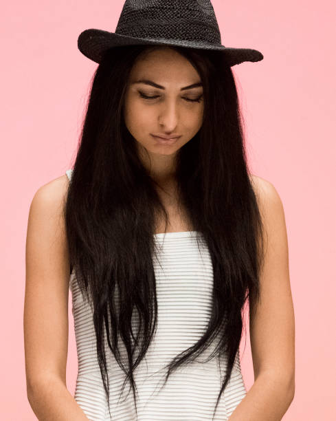 istock Beautiful female on pink background is crying 1170541608