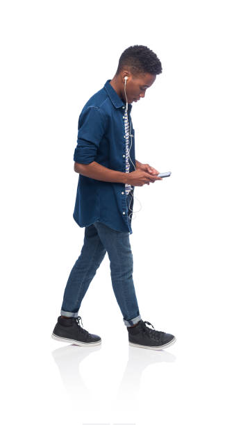 istock Young male walking and using phone 1170541857