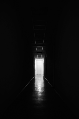 White door at the end of a black long corridor, mystic.