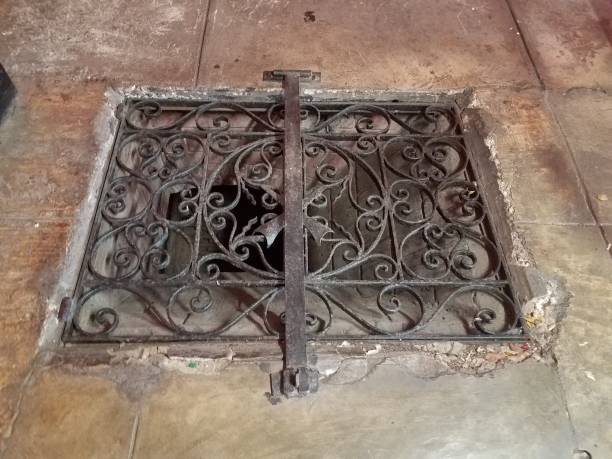 istock iron metal grate on opening in stone floor 1170550862