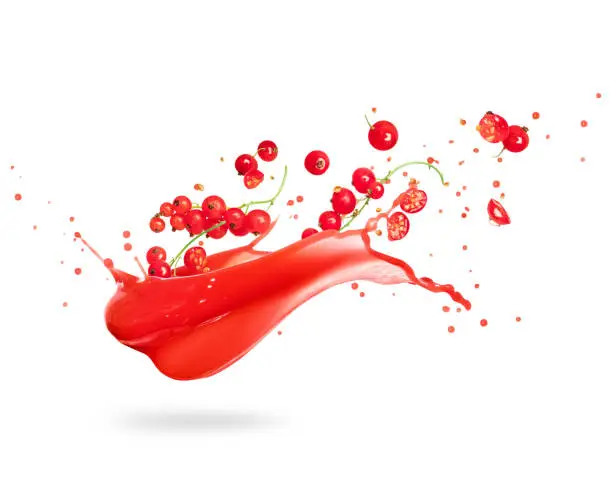 Redcurrant with splashes of fresh juice, isolated on white background