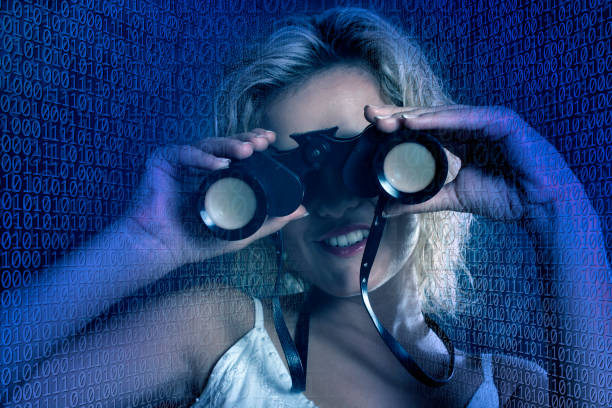 istock portrait of young woman looking through binocular in binary codes 1170551110