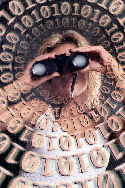 istock portrait of young woman looking through binocular in binary codes 1170551939