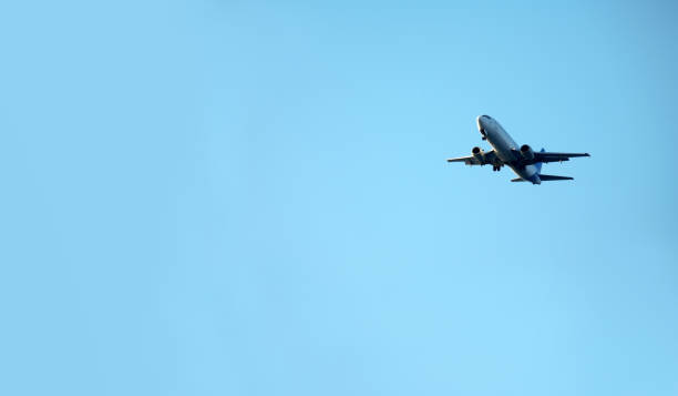 istock flying commercial passenger airplane over blue sky 1170552794
