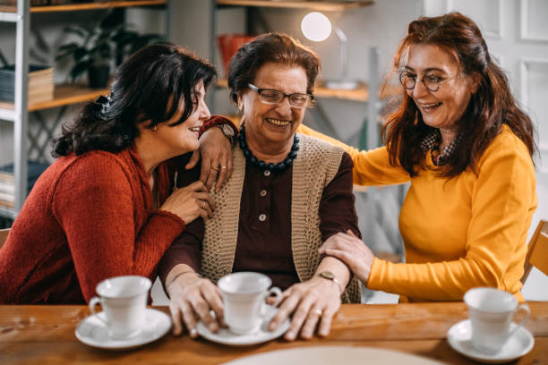 istock Three old women making conversation at home, having small tea party 1170553729