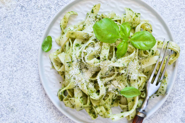 istock Tagliatelle with pesto on the kitchen table. View from above. 1170554889