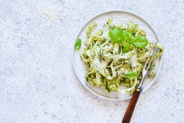 istock Tagliatelle with pesto on the kitchen table. View from above. 1170554891