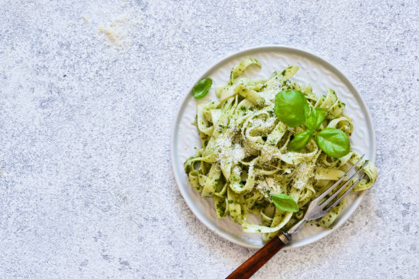 istock Tagliatelle with pesto on the kitchen table. View from above. 1170554900
