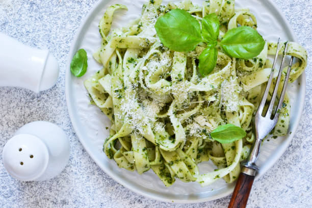 istock Tagliatelle with pesto on the kitchen table. View from above. 1170554923