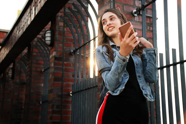 istock Happy girl using smartphone 1170556444