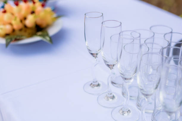 Crystal glasses of champagne on the wedding Reception table. Table setting for an event party or wedding reception at the beach. dinner set romantic wedding Decoration.