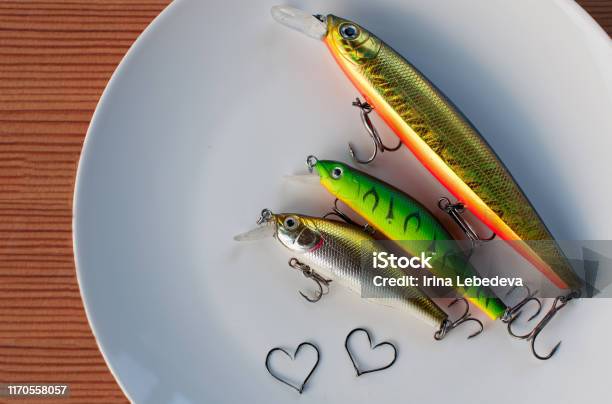 Colored Bait For Fish With Sharp Fishing Hooks In The Form Of Hearts Lies On  A White Plate On A Wooden Table Stock Photo - Download Image Now - iStock