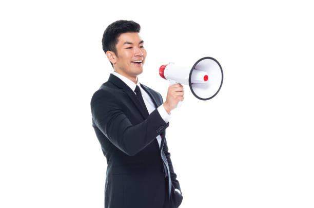 istock Attractive looking Chinese businessman - using a megaphone 1170560605