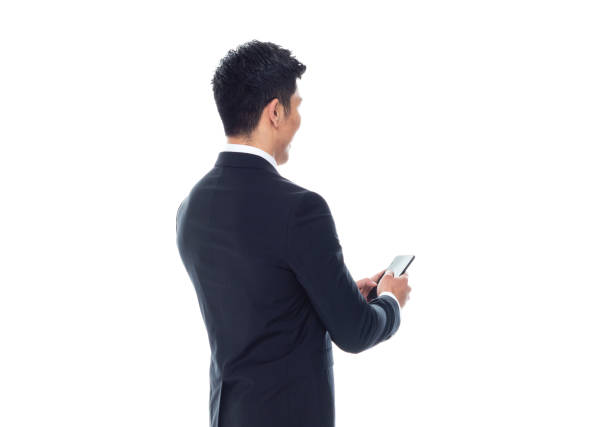 istock Attractive Asian businessman on white background - texting on phone 1170560607
