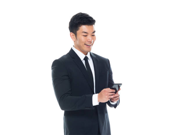 istock Attractive Asian businessman on white background - texting on phone 1170560829