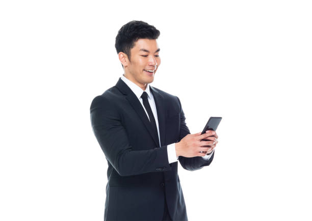 istock Attractive looking Chinese businessman - texting on smart phone 1170560892