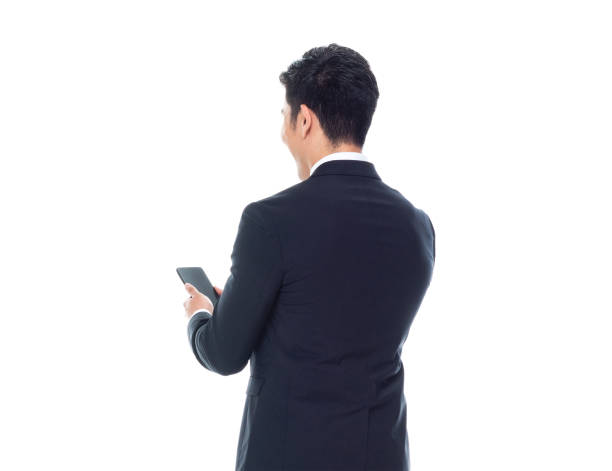 istock Attractive looking Chinese businessman - texting on smart phone 1170560894