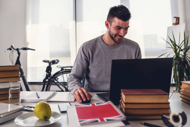 istock Young man, college student studying for an exam 1170561795