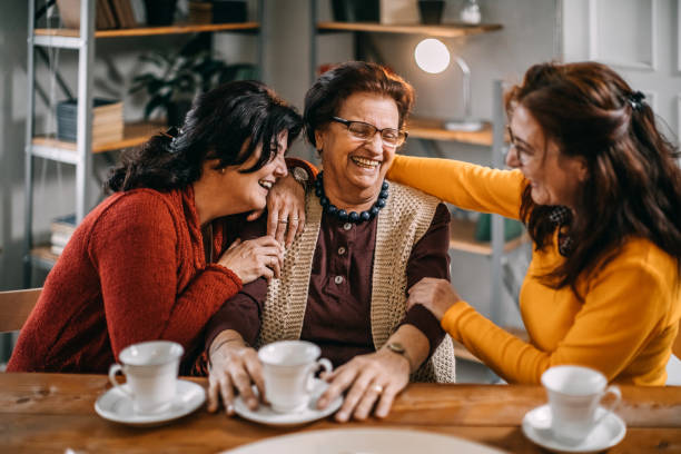 istock Three old women making conversation at home, having small tea party 1170562036