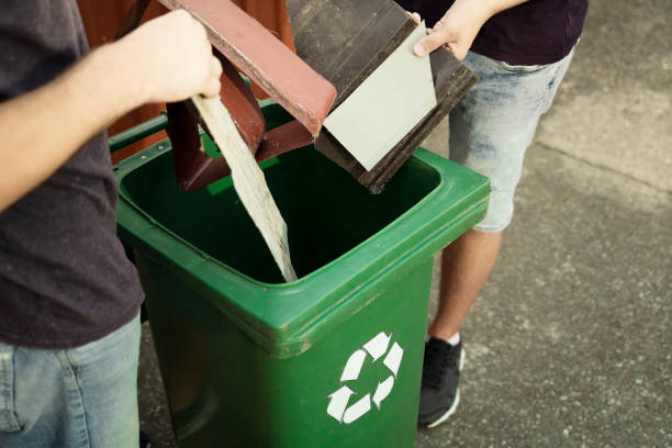istock Man putting scrap metal into recycle bin 1170563377