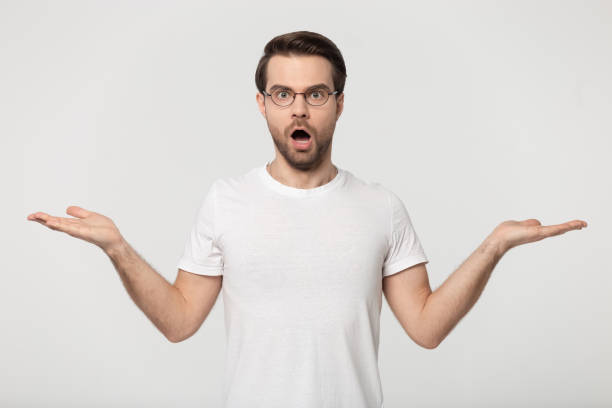 istock Shocked guy stretched open palms posing isolated on grey background 1170564001