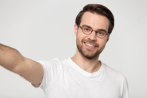 Webcam view guy wearing glasses looking at camera studio shot