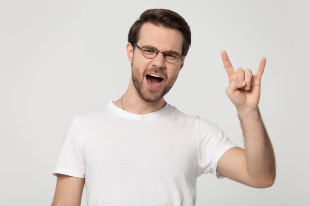 istock Millennial man in glasses showing rock and roll hand gesture 1170564041