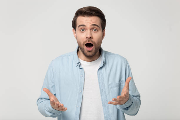 istock Amazed guy open mouth raising spread palms feels impressed 1170564057