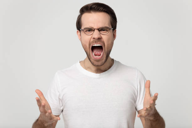 istock Screaming guy in glasses isolated on gray background 1170564075