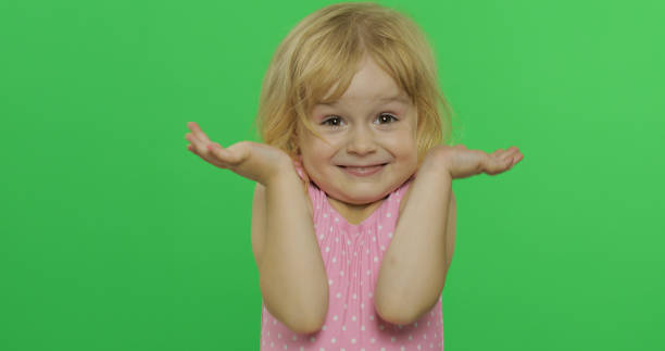 istock Girl emotionally makes faces and shows a hand gesture that she doesn't know 1170564779