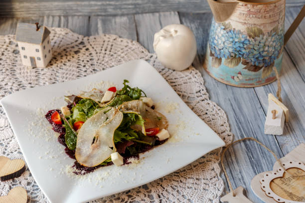 istock beetroot,tomato,pear and green salad with cheese on a white plate 1170566199