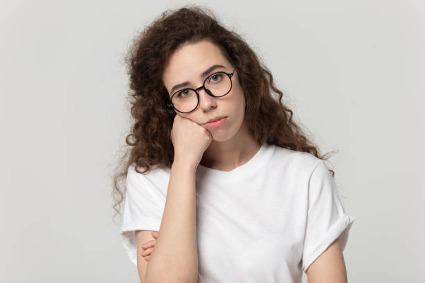 istock Bored young woman posing on grey studio background 1170566407