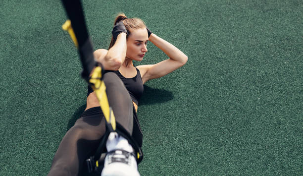 istock High angle view of a female athlete doing crunches using suspension strap 1170566538