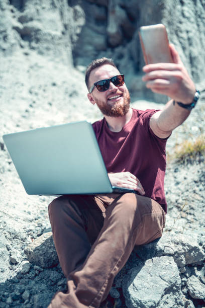 istock Handsome Male Taking Selfie While Working In Nature 1170569994