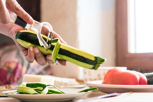 Close Up Woman Hands Peeling Fresh Zucchini