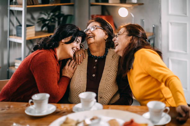 istock Three old women making conversation at home, having small tea party 1170573695
