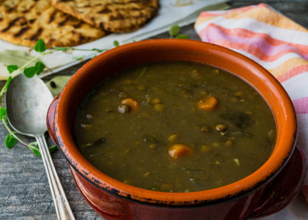 istock Lentil soup in a red clay bowl with a spoon. 1170575173
