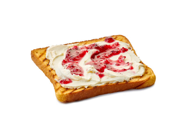 Granary bread toast with melting butter on a white background.