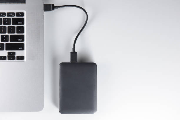 istock laptop and mobile hard drive 1170584878