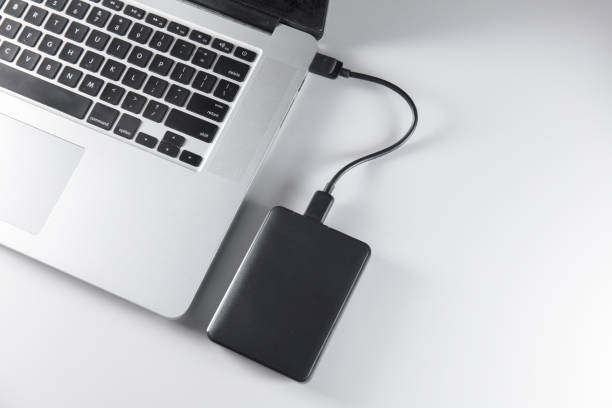 istock laptop and mobile hard drive 1170584886